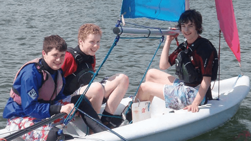 3 boys in boat