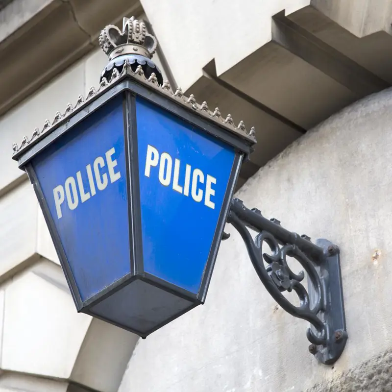 Traditional blue police lantern mounted on a stone building