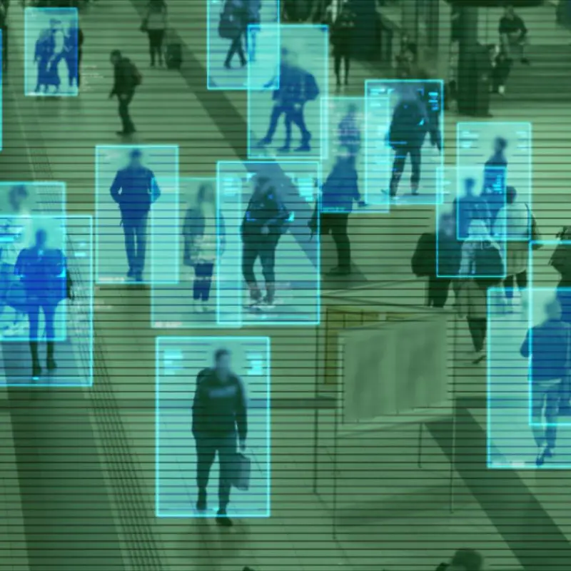 AI-powered surveillance system detecting and tracking people in a public space.