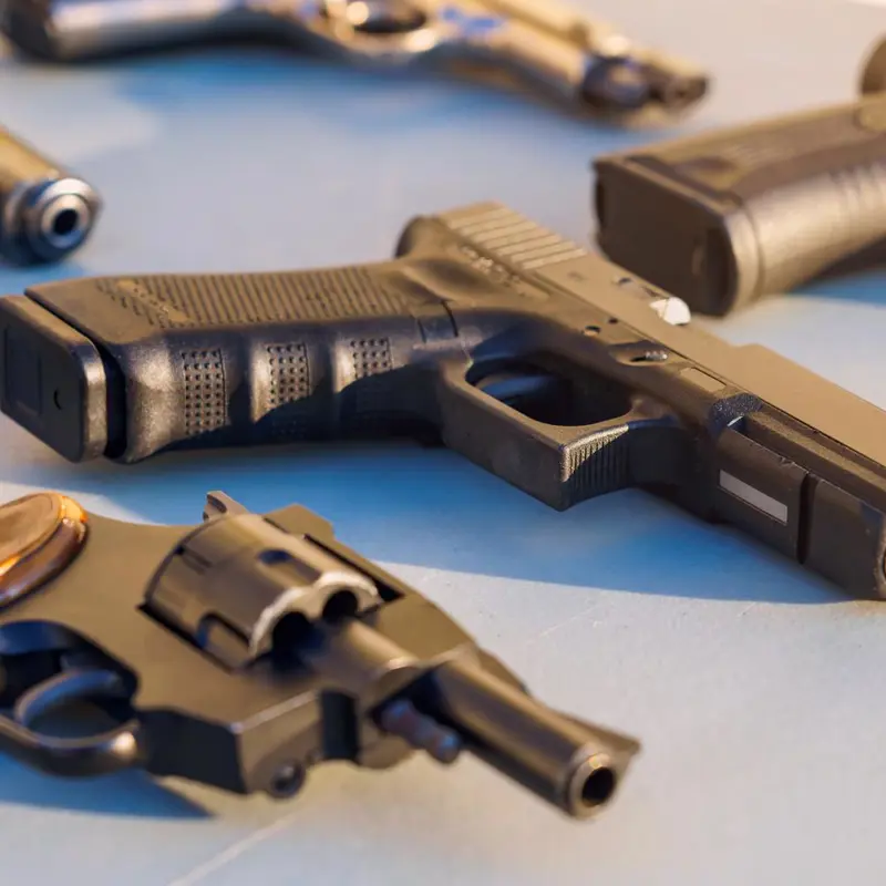 Collection of various handguns laid out on a surface.